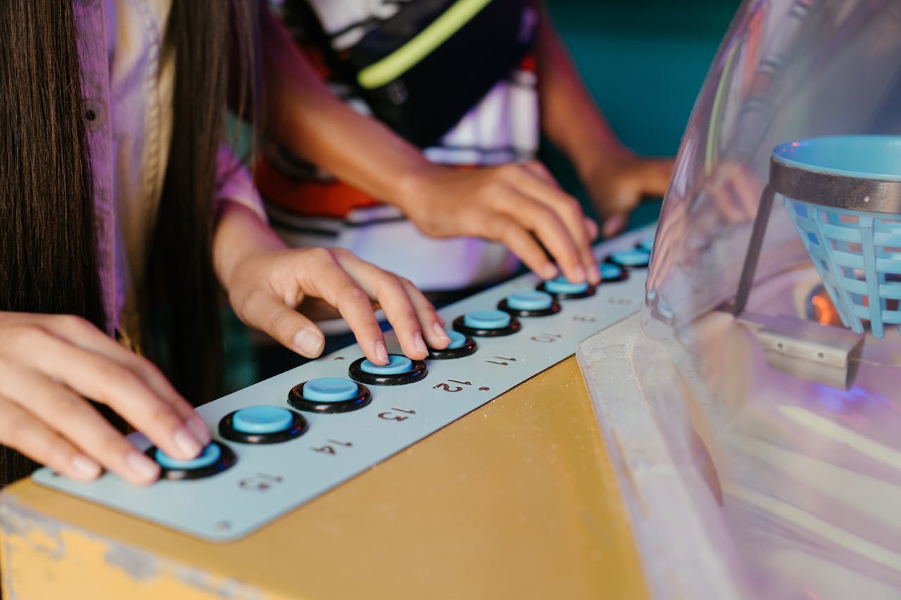 Children enjoy a fun playtime with a retro arcade button board indoors.